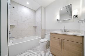 Philadelphia apartment for rent - a bathroom with a toilet sink and shower and a mirror